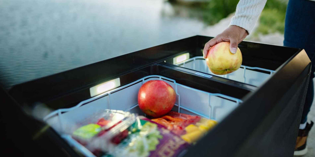 A fridge with food, fruit, and ice creams