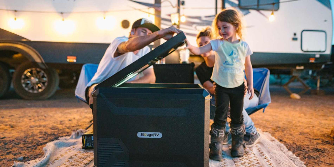 A little girl opening up BougeRV’s Van Life fridge during camping