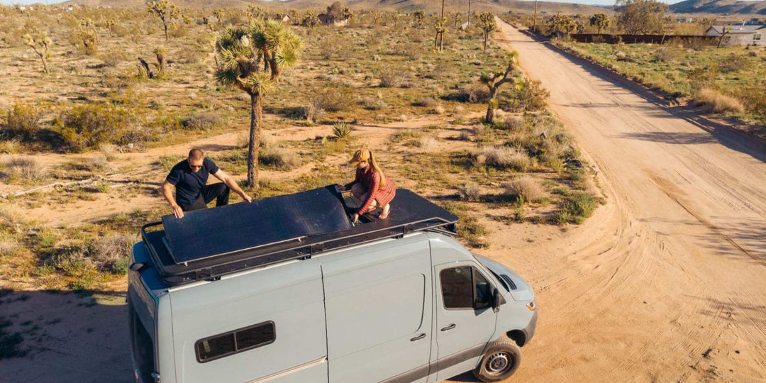 A man and a woman Installing BougeRV’s CIGS flexible solar panels on their Van roof