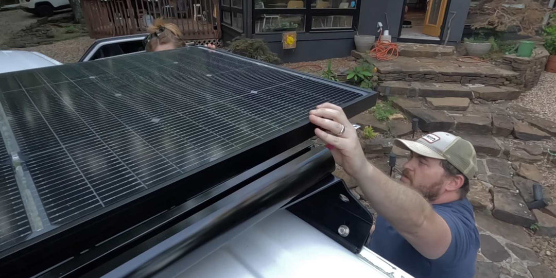 A man installing BougeRV 24V TopCon solar panel for his RV