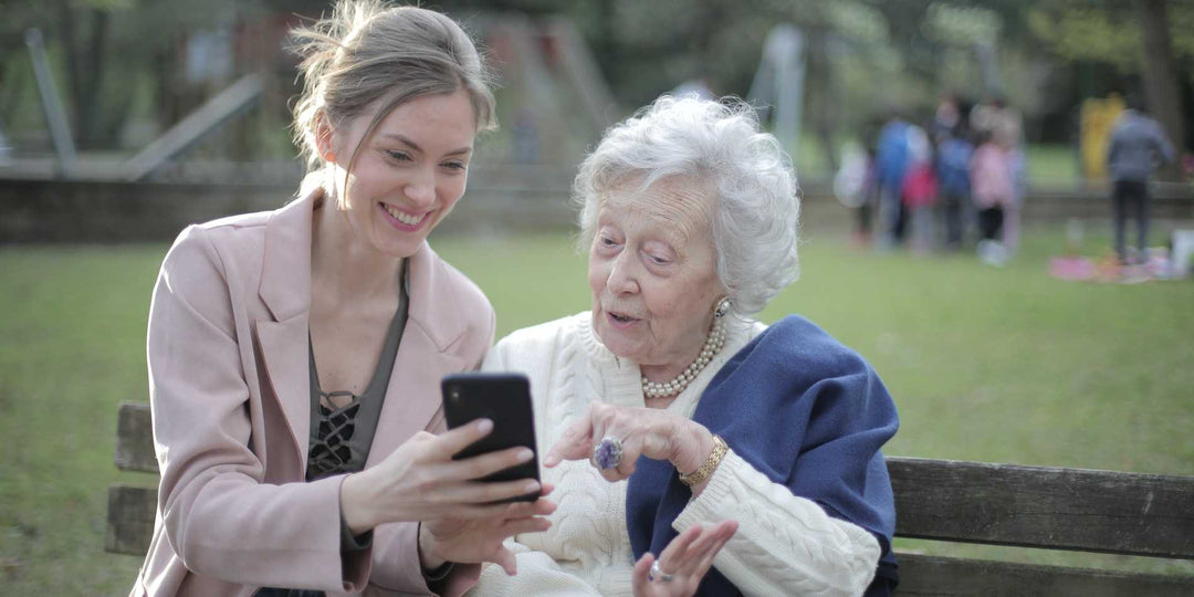 A mom is looking at the phone with a young lady