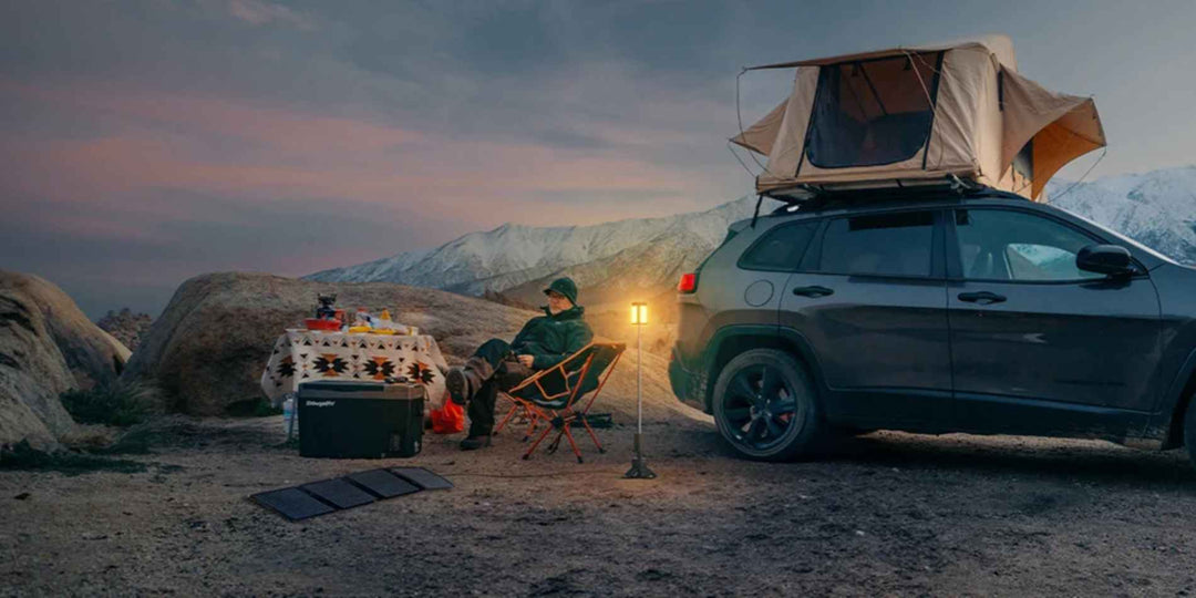 A man using BougeRV's portable camping lantern while RV camping in the evening