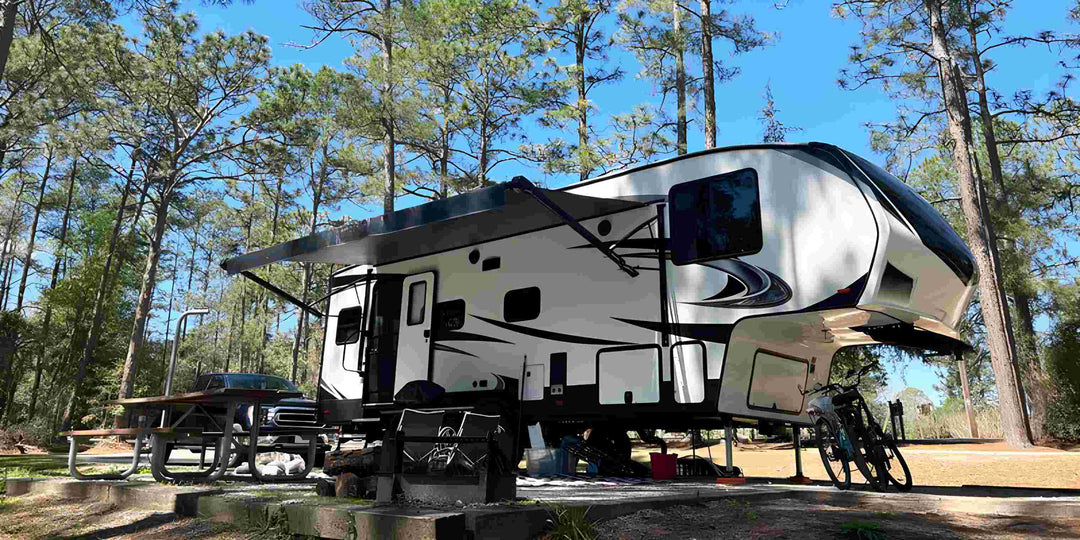 A 5th wheel camper in the forest