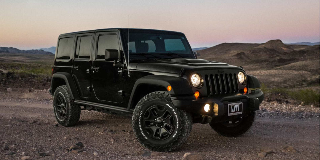 A black Jeep Wrangler parked on the road