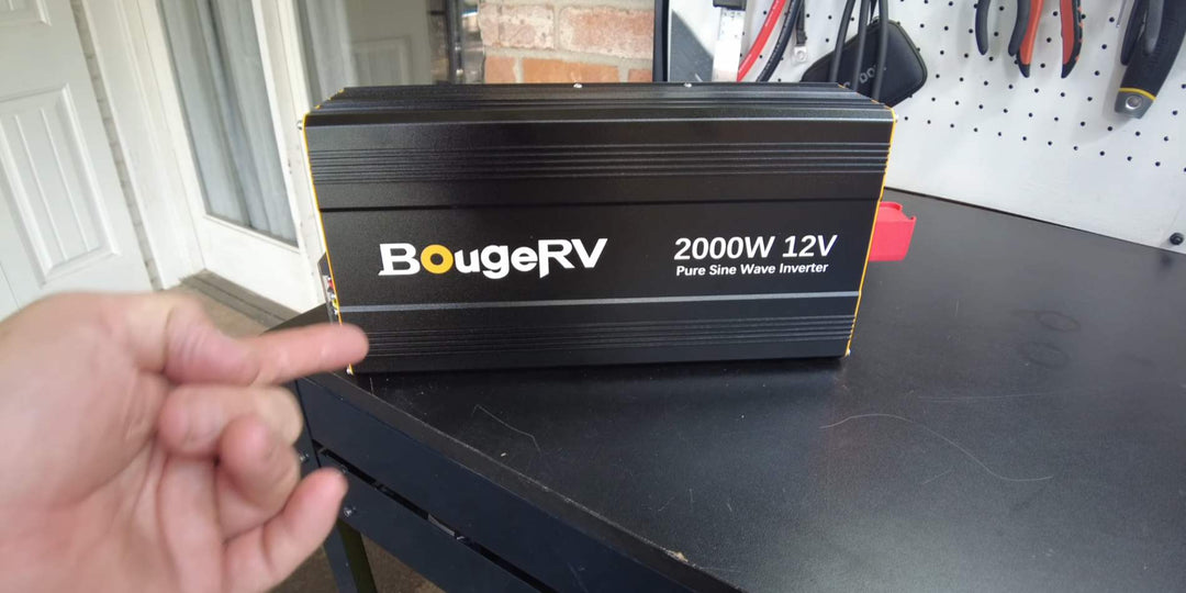 A man pointing a BougeRV’s pure sine wave inverter