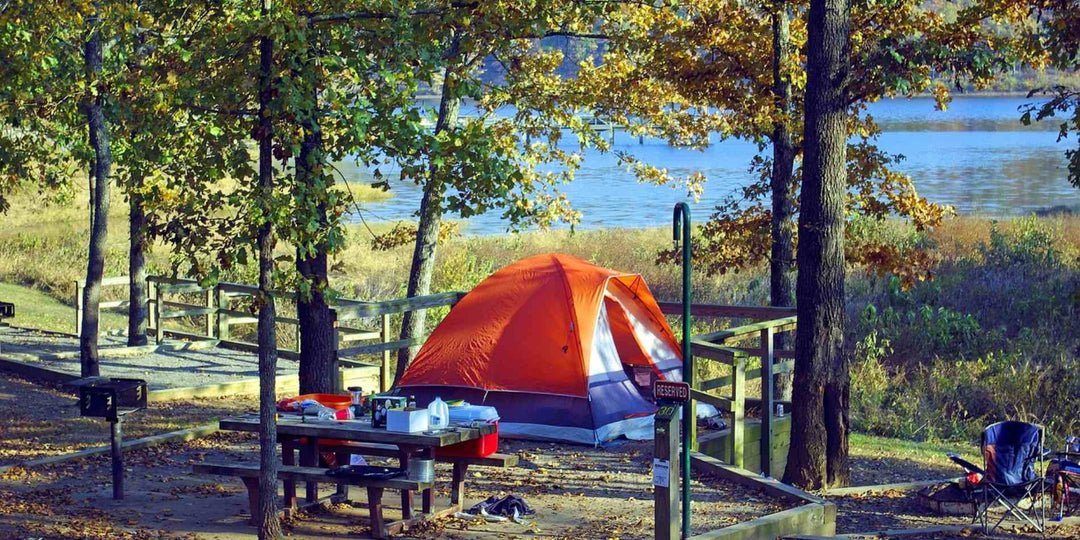 Tent camping in the wooded hollow by a lake