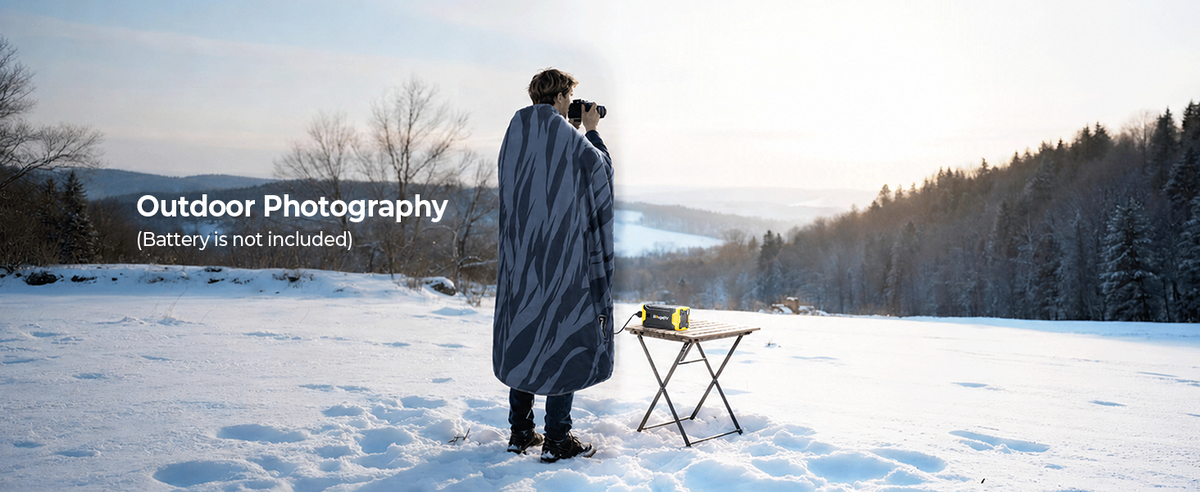 Outdoor photographer using a BougeRV portable heated blanket while taking photos in cool weather