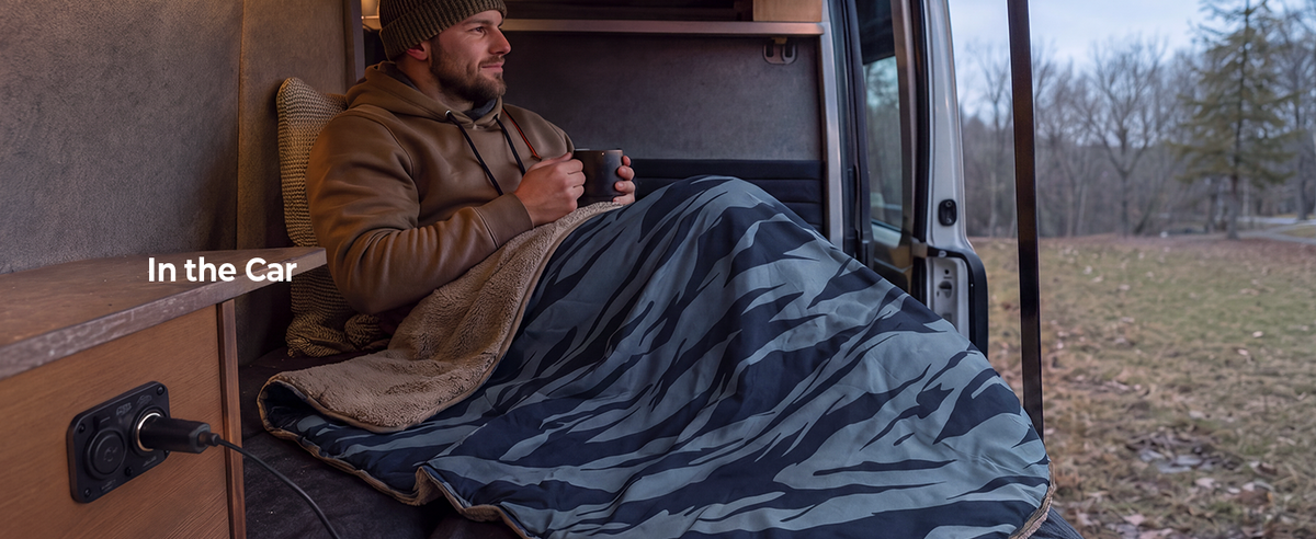 Person relaxing in a car with a warm drink and BougeRV 12V heated blanket while enjoying the outdoor view