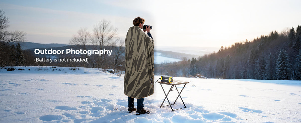 Outdoor photographer using a BougeRV portable heated blanket while shooting in cool weather
