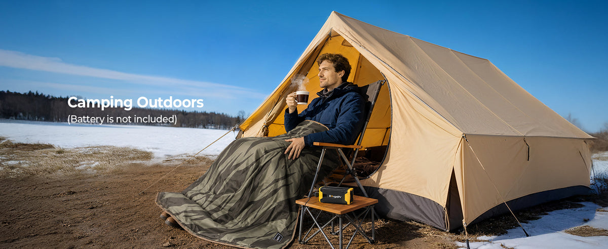 Person sitting outside a tent in a camping chair with a BougeRV heated blanket
