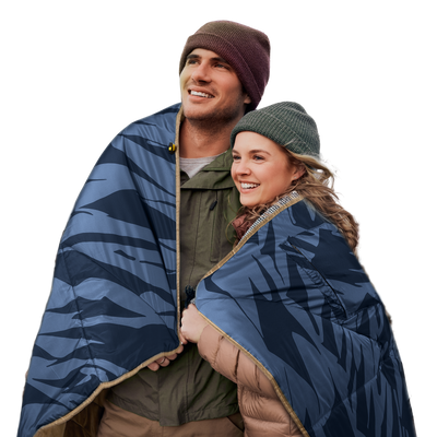 Two people wrapped in a blue-patterned 12V heated blanket