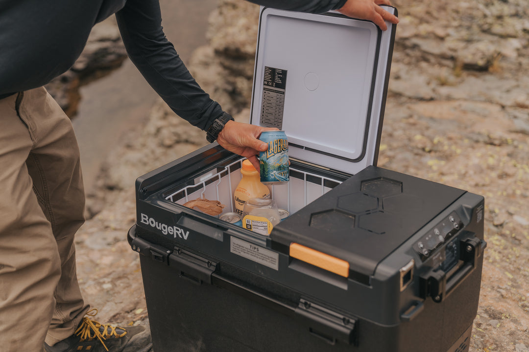 Person opening a BougeRV crd2 cooler  outdoors